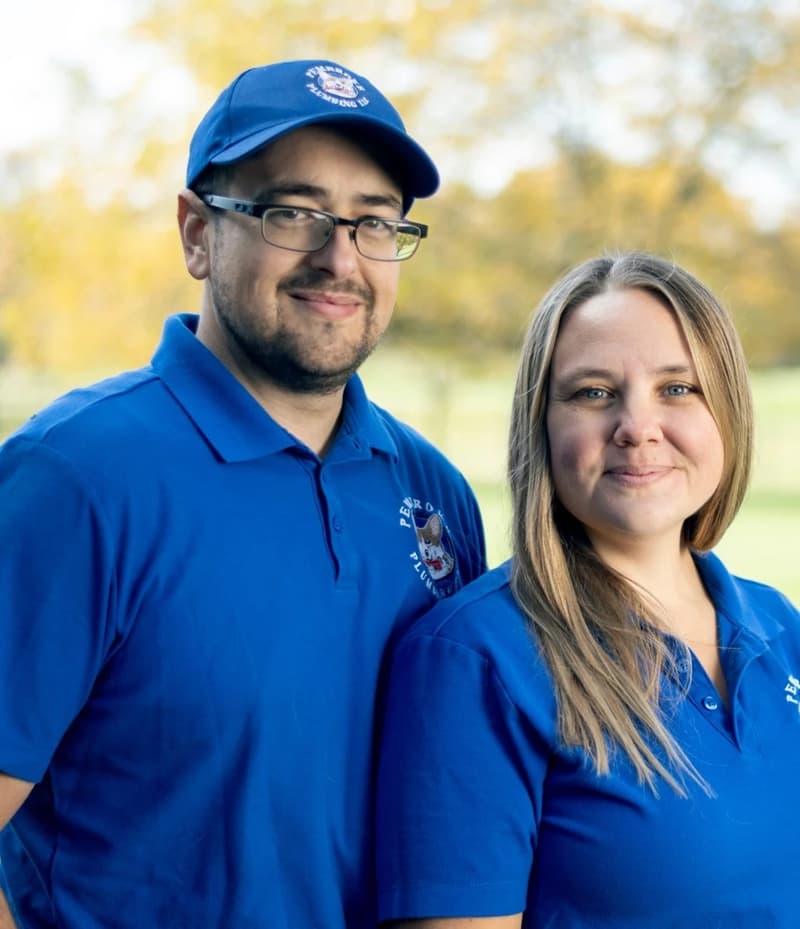 Man and woman in blue company polo shirts outdoors