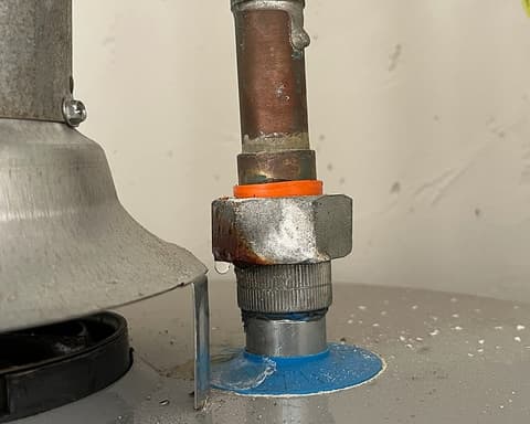Close-up of water heater pipe connection